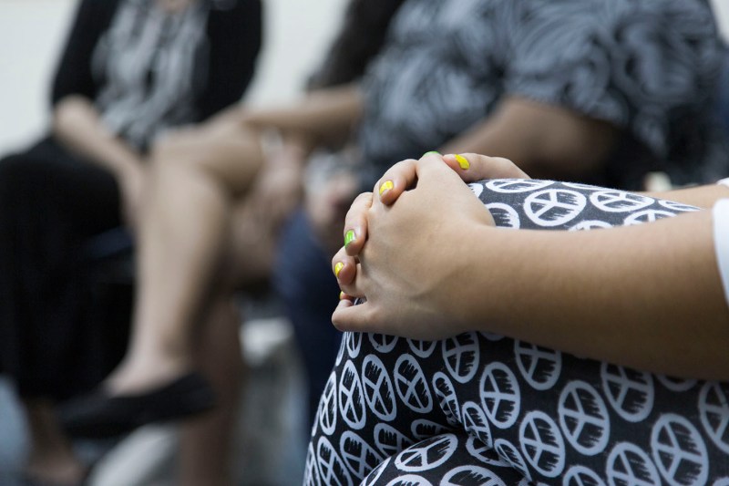 woman's hands over knees